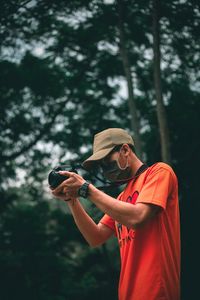 Midsection of person wearing sunglasses standing outdoors