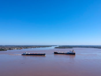 Scenic view of sea against clear blue sky