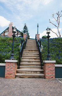 Staircase by building against sky