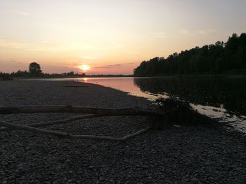 Scenic view of beach against sky during sunset