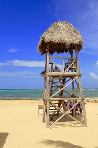 Lifeguard hut on beach against sky