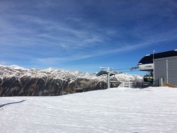 Snow covered mountain against blue sky