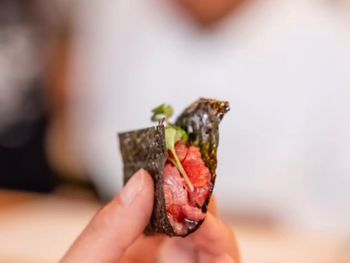 Cropped hand of woman holding food
