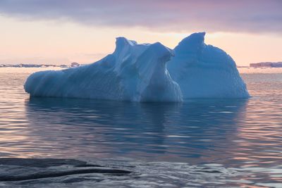 Scenic view of frozen sea against sky during sunset