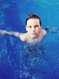 Portrait of boy swimming in pool