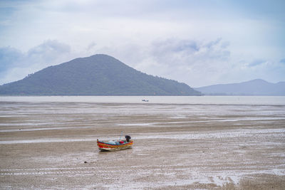 Scenic view of sea and mountains against sky