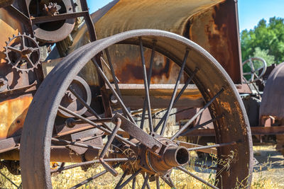 Old rusty wheel on field