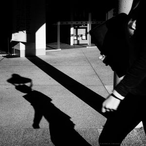 Shadow of man on woman in city