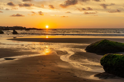 Scenic view of beach against sky during sunset