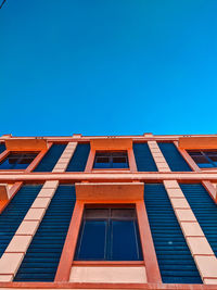 Low angle view of building against clear blue sky