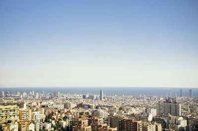 View of cityscape against blue sky