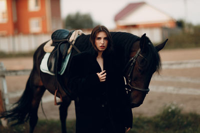 Portrait of young woman riding horse