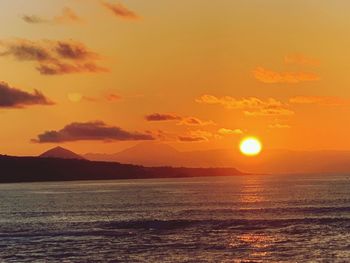 Scenic view of sea against romantic sky at sunset