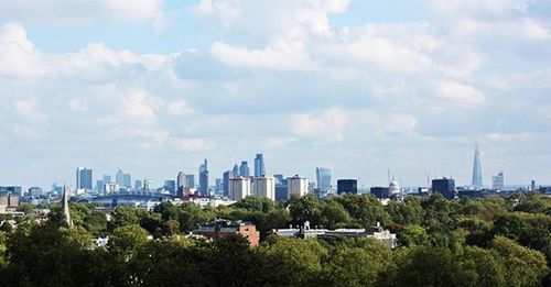 Cityscape against cloudy sky