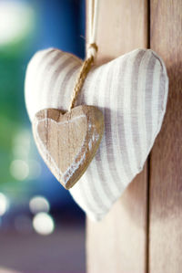 Close-up of heart shape hanging on wood
