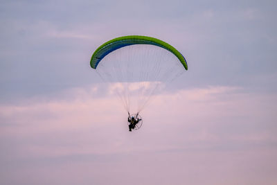 Person paragliding against sky