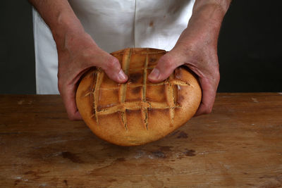 Breaking of a fresh loaf of eucharistic bread