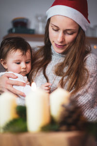 Portrait of young woman mother and 2 year old child at christmas time