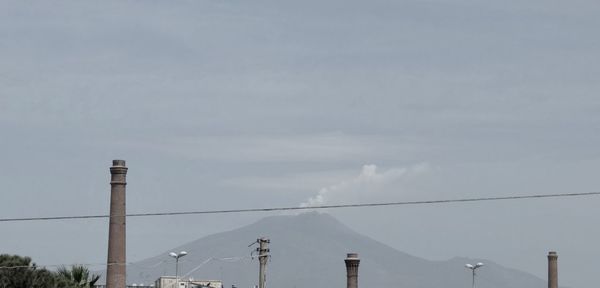 Low angle view of crane against sky