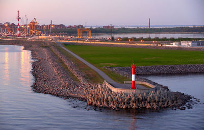 Bridge over river in city against clear sky