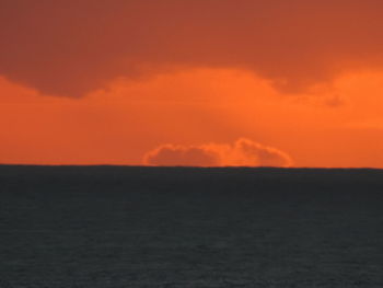 Scenic view of landscape against orange sky