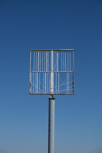 Low angle view of metallic structure against clear blue sky