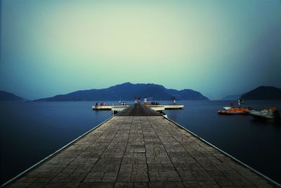 Calm sea with mountain range in background