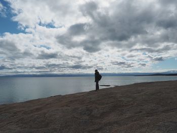 Man standing on beach against sky