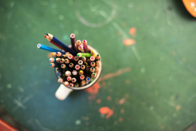 Close-up of colorful pencils in container on table