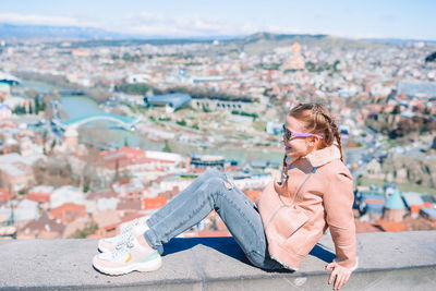 Young woman sitting outdoors