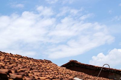 Low angle view of roofs against sky