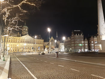 City street against sky at night