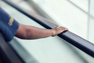 Close-up of hand holding window