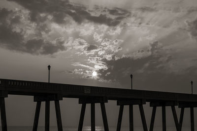 Low angle view of bridge against sky at sunset