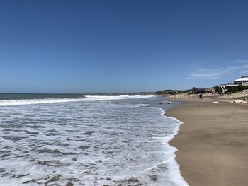 Scenic view of beach against clear sky