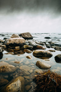 Rocks on beach against sky