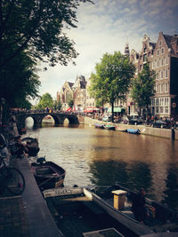 Boats in river with buildings in background