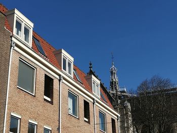 Low angle view of buildings against blue sky