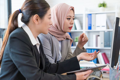 Woman using mobile phone in laptop
