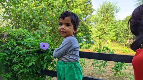 Full length of happy girl with flowers