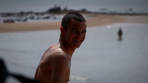 Portrait of smiling young man at beach