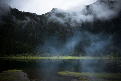 Scenic view of lake and mountains against sky