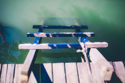 High angle view of deck chairs against sea