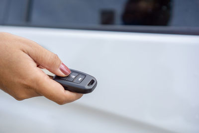 Midsection of man holding mobile phone