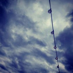 Low angle view of tower against cloudy sky