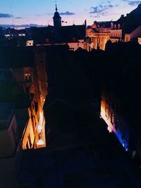 Illuminated buildings against sky at night