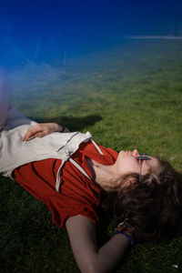 Low section of woman lying on grass