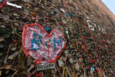 Close-up of heart shape made on multi colored text