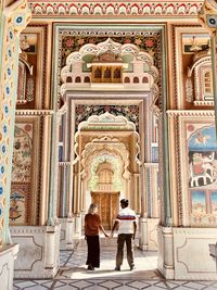 Rear view of people in temple outside building