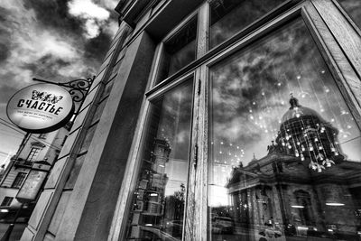 Low angle view of building against cloudy sky